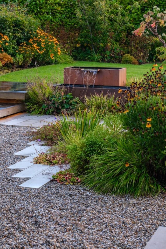 Water feature alongside the path and set in planting