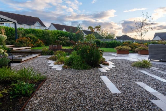 Gravel area with stepping stones and planting and a place for multi-use